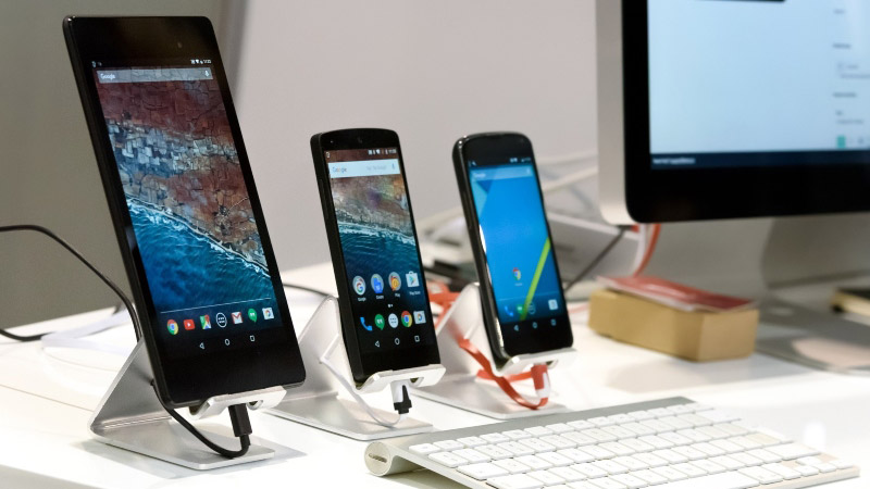 three smart phones and a computer